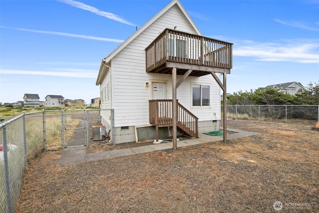 rear view of house with a fenced backyard, crawl space, a gate, and central AC