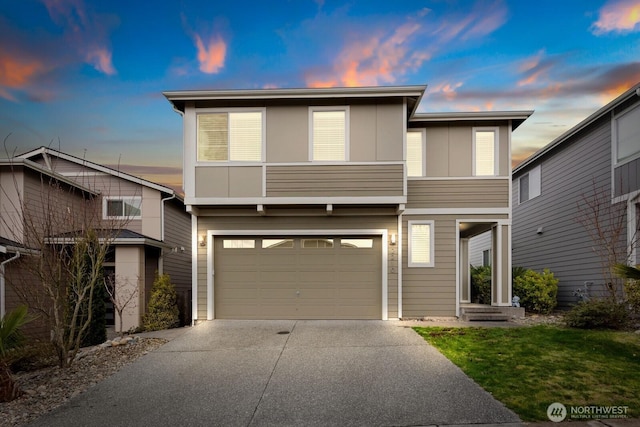 view of front of property featuring concrete driveway and an attached garage