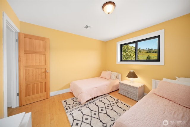 696 Texas Creek Rd, Carlton, WA 98814 - bedroom featuring baseboards, visible vents, and wood finished floors
