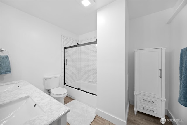 696 Texas Creek Rd, Carlton, WA 98814 - full bath featuring shower / bath combination with glass door, a sink, double vanity, toilet, and wood finished floors