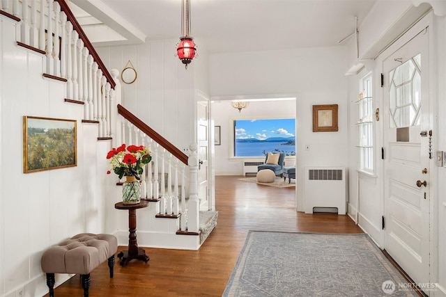 4201 N Mason St, Tacoma, WA 98407 - foyer with radiator heating unit, stairs, wood finished floors, and healthy amount of natural light