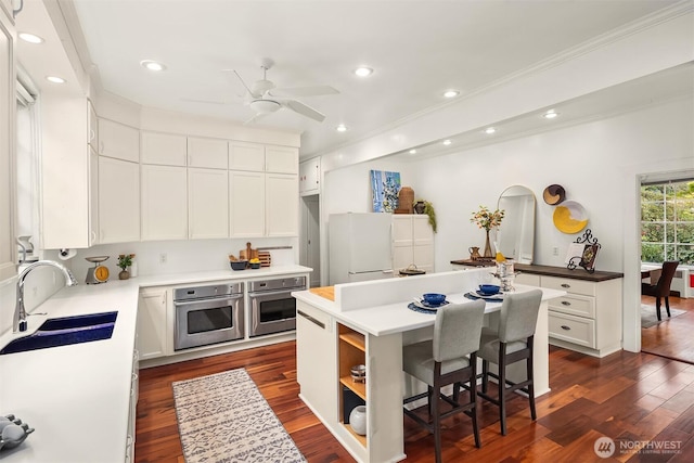 4201 N Mason St, Tacoma, WA 98407 - kitchen featuring a sink, stainless steel oven, freestanding refrigerator, crown molding, and a center island