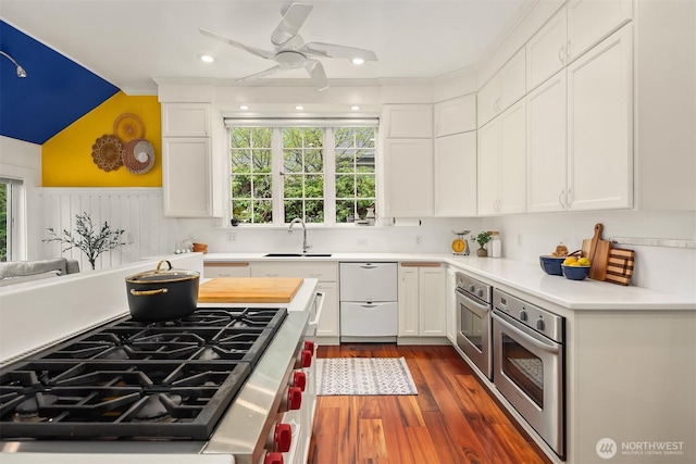 4201 N Mason St, Tacoma, WA 98407 - kitchen featuring stainless steel appliances, a sink, white cabinets, light countertops, and vaulted ceiling