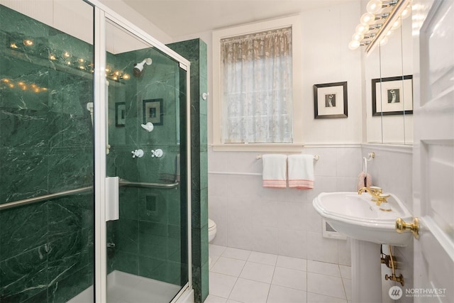 4201 N Mason St, Tacoma, WA 98407 - bathroom with tile patterned floors, a stall shower, toilet, and tile walls