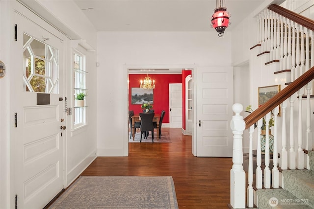 4201 N Mason St, Tacoma, WA 98407 - foyer entrance with dark wood-type flooring, stairs, a chandelier, and baseboards