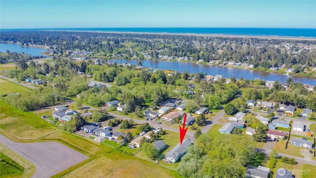 drone / aerial view with a water view and a residential view