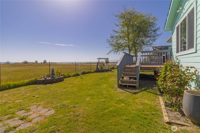 view of yard with a wooden deck and stairs