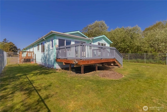 back of house featuring a lawn, a fenced backyard, and a deck