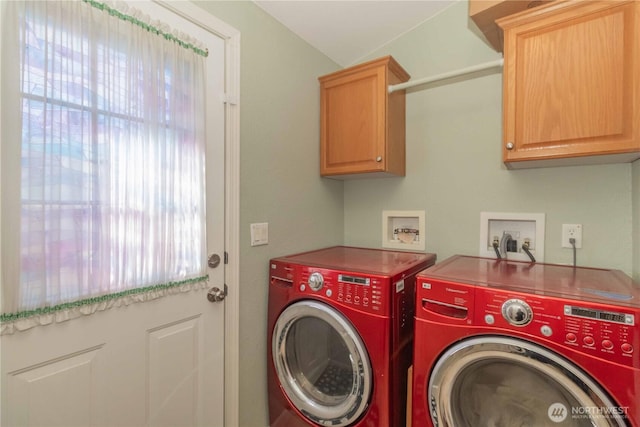 washroom featuring cabinet space and independent washer and dryer