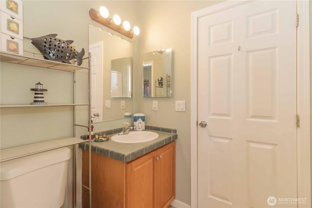 bathroom featuring vanity and toilet