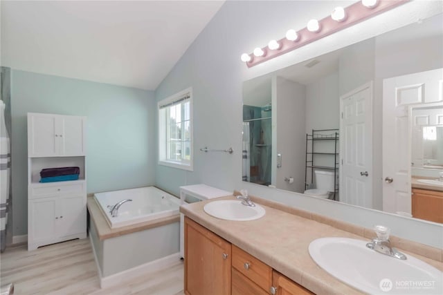 full bathroom featuring double vanity, a sink, an enclosed shower, and a garden tub