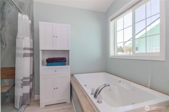 full bathroom with a heating unit, curtained shower, a tub with jets, and wood finished floors