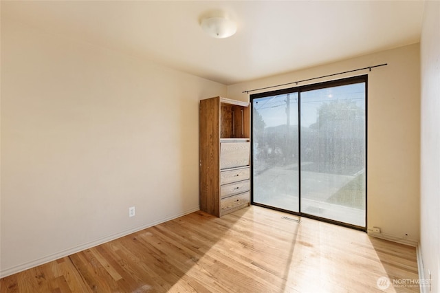 129 G St SE, Ephrata, WA 98823 - unfurnished bedroom featuring access to outside, light wood-style floors, and baseboards