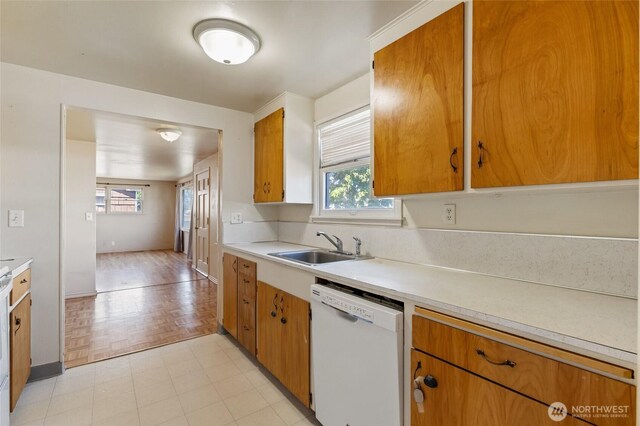 129 G St SE, Ephrata, WA 98823 - kitchen with white dishwasher, a sink, and light countertops
