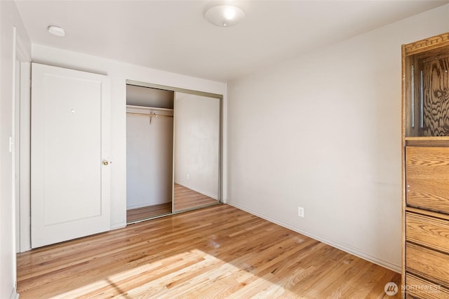 129 G St SE, Ephrata, WA 98823 - unfurnished bedroom with light wood-style floors, a closet, and baseboards