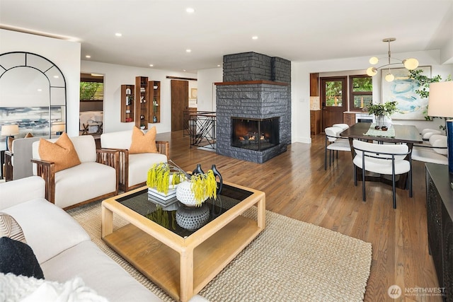 living room with wood finished floors, plenty of natural light, a fireplace, and recessed lighting
