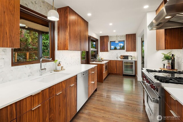 kitchen featuring wine cooler, stainless steel appliances, extractor fan, modern cabinets, and recessed lighting