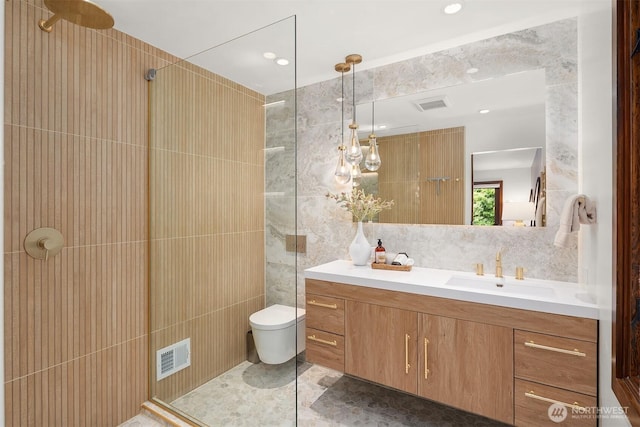 bathroom featuring tile walls, a walk in shower, vanity, toilet, and recessed lighting