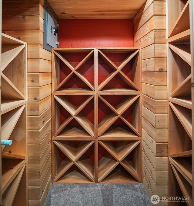 wine room with carpet and wooden ceiling