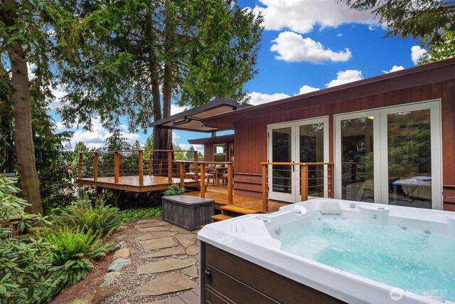 view of patio with a wooden deck and a hot tub