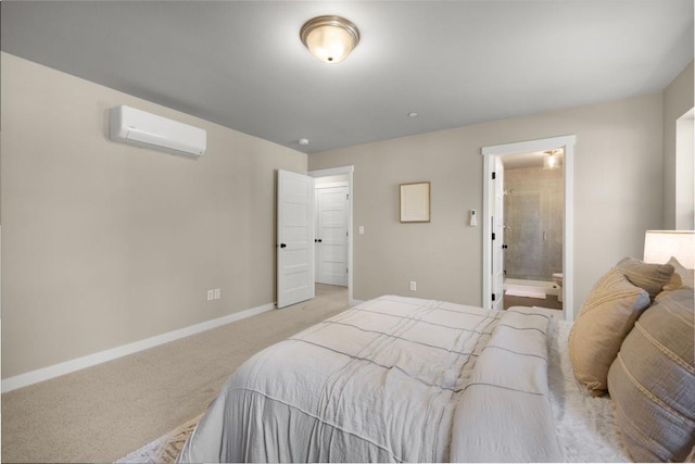 bedroom featuring baseboards, ensuite bathroom, a wall mounted AC, and light colored carpet
