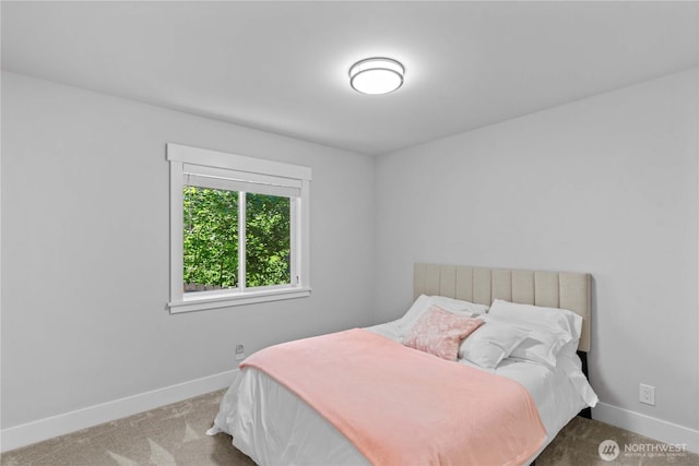 carpeted bedroom featuring baseboards