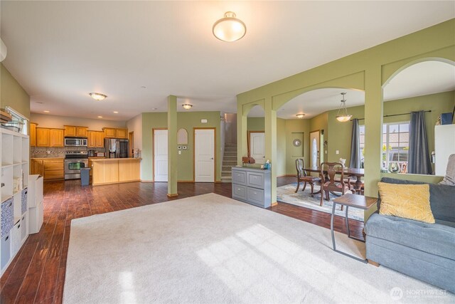 1006 Cathleen St, Port Angeles, WA 98363 - living area with arched walkways, dark wood-style floors, and recessed lighting