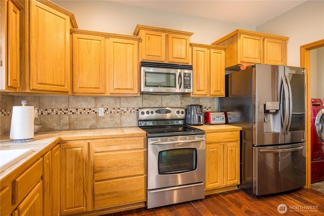 1006 Cathleen St, Port Angeles, WA 98363 - kitchen featuring dark wood-style floors, backsplash, tile counters, and appliances with stainless steel finishes
