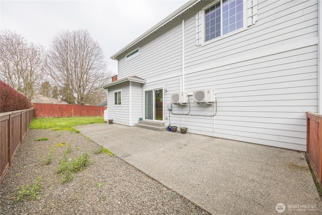 1006 Cathleen St, Port Angeles, WA 98363 - rear view of house with a fenced backyard, an AC wall unit, and a patio