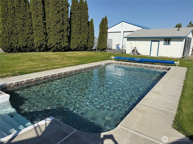 view of swimming pool with a lawn and a covered pool