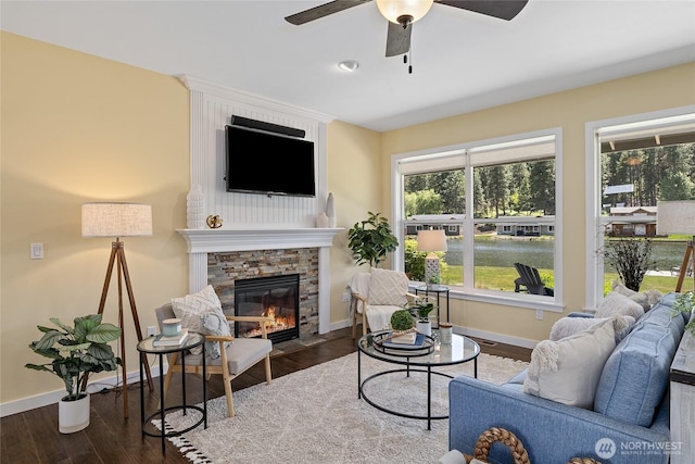1140 Twin Lakes Rd, Cle Elum, WA 98922 - living area with a ceiling fan, baseboards, a fireplace, and wood finished floors