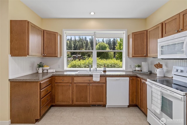 1140 Twin Lakes Rd, Cle Elum, WA 98922 - kitchen with white appliances, a sink, brown cabinets, light tile patterned floors, and recessed lighting