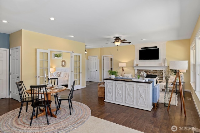 1140 Twin Lakes Rd, Cle Elum, WA 98922 - dining space featuring french doors, a ceiling fan, dark wood finished floors, a stone fireplace, and recessed lighting