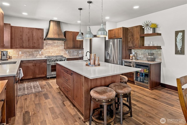 31 Powder Cap Ct, Cle Elum, WA 98922 - kitchen featuring a sink, light countertops, appliances with stainless steel finishes, custom range hood, and beverage cooler