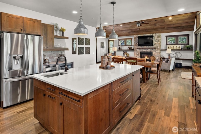 31 Powder Cap Ct, Cle Elum, WA 98922 - kitchen featuring stainless steel fridge with ice dispenser, dark wood-type flooring, open shelves, a stone fireplace, and a sink