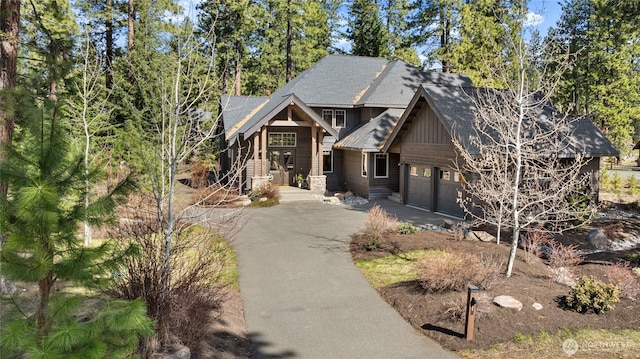 31 Powder Cap Ct, Cle Elum, WA 98922 - view of front of house featuring a garage, aphalt driveway, roof with shingles, and board and batten siding