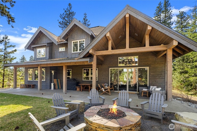 31 Powder Cap Ct, Cle Elum, WA 98922 - rear view of property featuring board and batten siding, a fire pit, a patio, and a yard