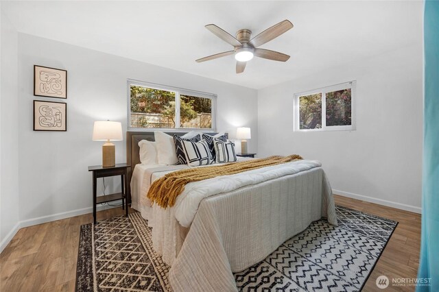 bedroom with baseboards, ceiling fan, and wood finished floors