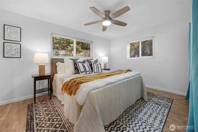bedroom featuring baseboards, ceiling fan, and wood finished floors