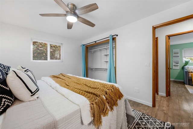 bedroom featuring baseboards, a ceiling fan, and wood finished floors
