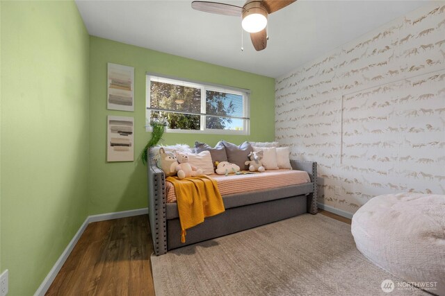 bedroom with baseboards, a ceiling fan, and wood finished floors