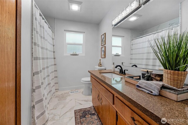 bathroom featuring vanity, toilet, marble finish floor, curtained shower, and visible vents