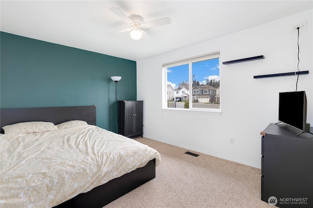 bedroom featuring a ceiling fan, carpet floors, baseboards, and visible vents