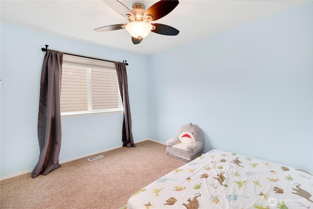 unfurnished bedroom with carpet flooring, baseboards, ceiling fan, and visible vents