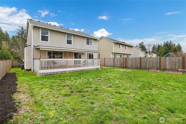 back of house featuring a lawn, central AC, a fenced backyard, and a deck