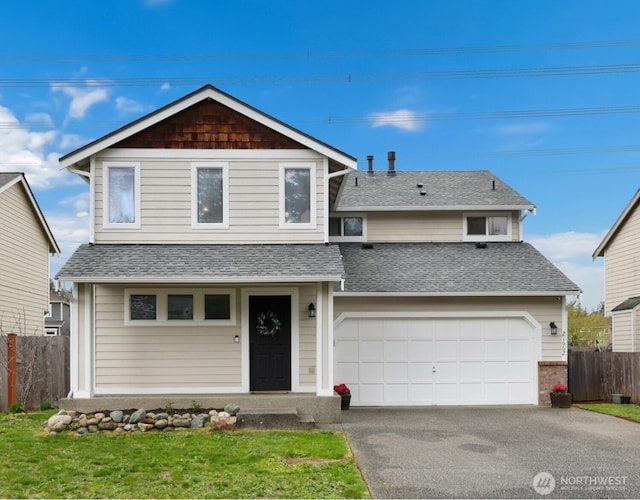 view of front of house with driveway, a garage, fence, and roof with shingles