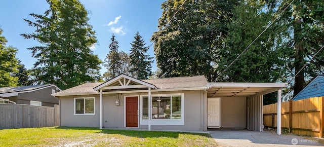 3513 NE 7th Pl, Renton, WA 98056 - view of front of property with a carport, concrete driveway, fence, and a front lawn