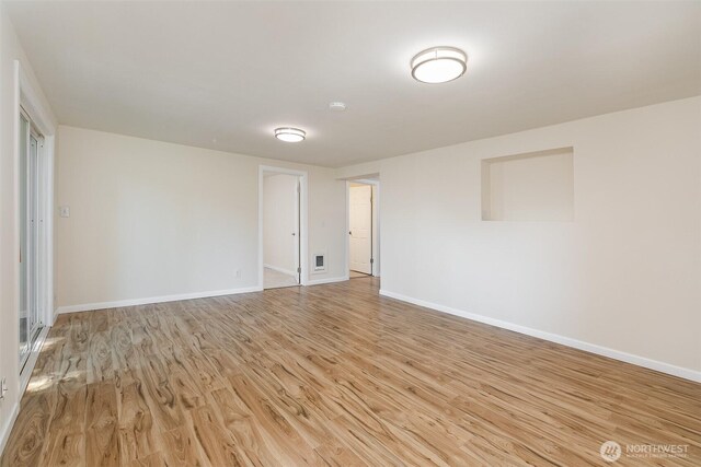 3513 NE 7th Pl, Renton, WA 98056 - empty room featuring visible vents, light wood-type flooring, and baseboards