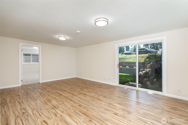 3513 NE 7th Pl, Renton, WA 98056 - spare room featuring light wood-style flooring, a healthy amount of sunlight, and baseboards