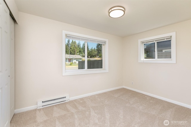 3513 NE 7th Pl, Renton, WA 98056 - spare room featuring carpet, a baseboard radiator, and baseboards